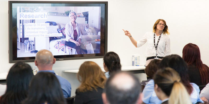 Jo presenting in front of a crowd at the DTO