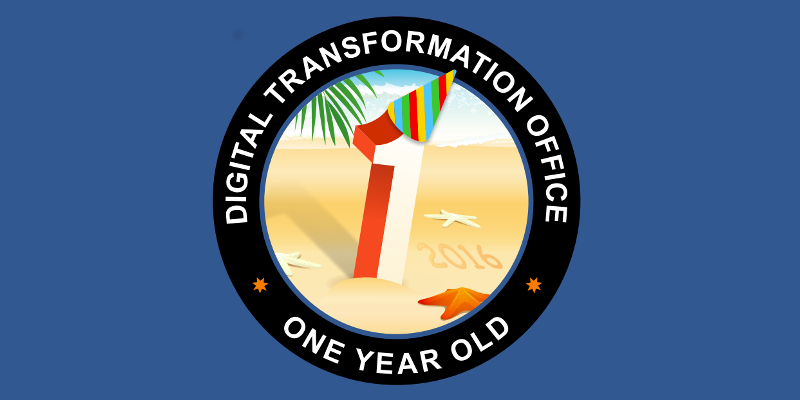 The number 1 on the beach with a party hat with the words Digital Transformation Office One Year Old. 