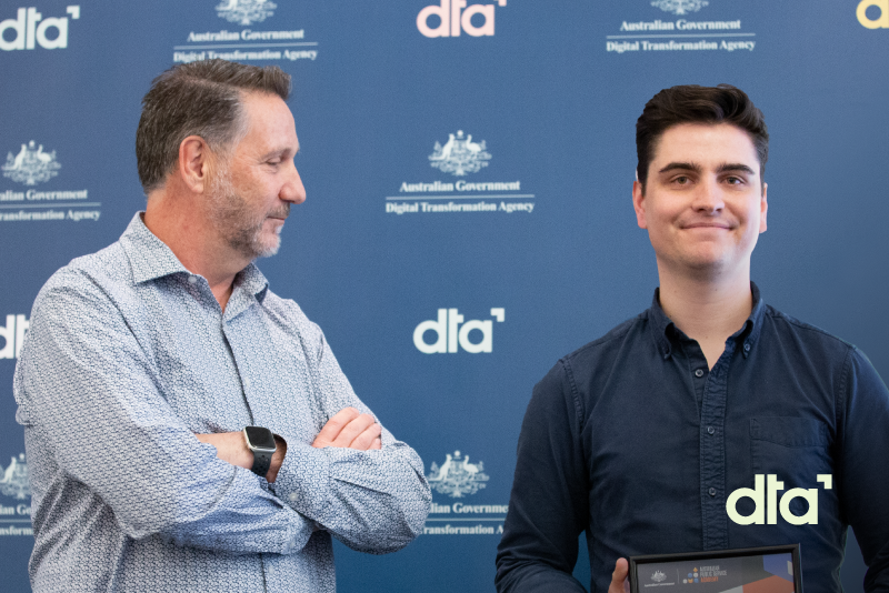 Person smiling while holding certificate