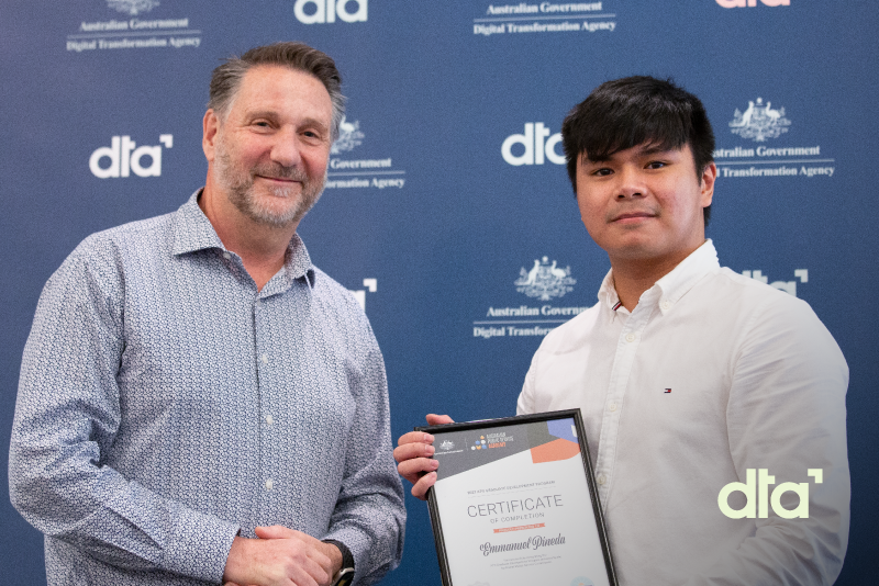 2 people smiling and holding a certificate